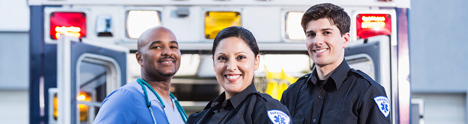 female EMT next to EMS ambulance